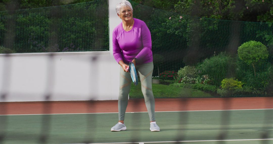 Senior Woman Playing Tennis on Outdoor Court - Free Images, Stock Photos and Pictures on Pikwizard.com