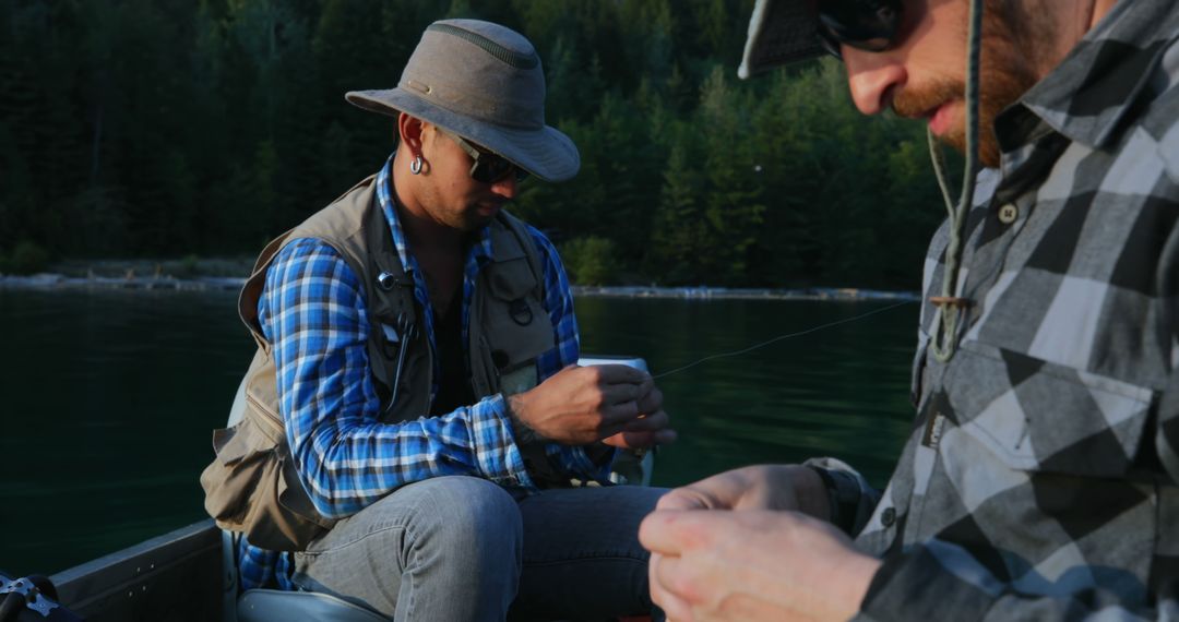 Two Fishermen Preparing Fishing Lines at Quiet Lake - Free Images, Stock Photos and Pictures on Pikwizard.com