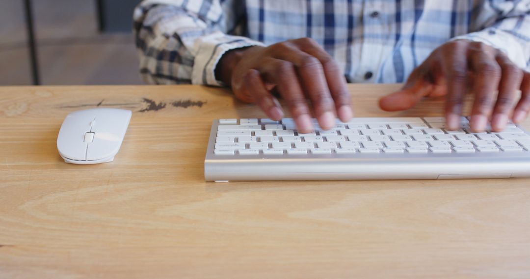 Focusing on Work by Typing on Keyboard at Office Desk