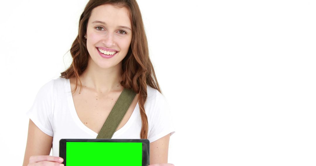 Smiling Young Woman Holding Green Screen Tablet Against White Background - Free Images, Stock Photos and Pictures on Pikwizard.com