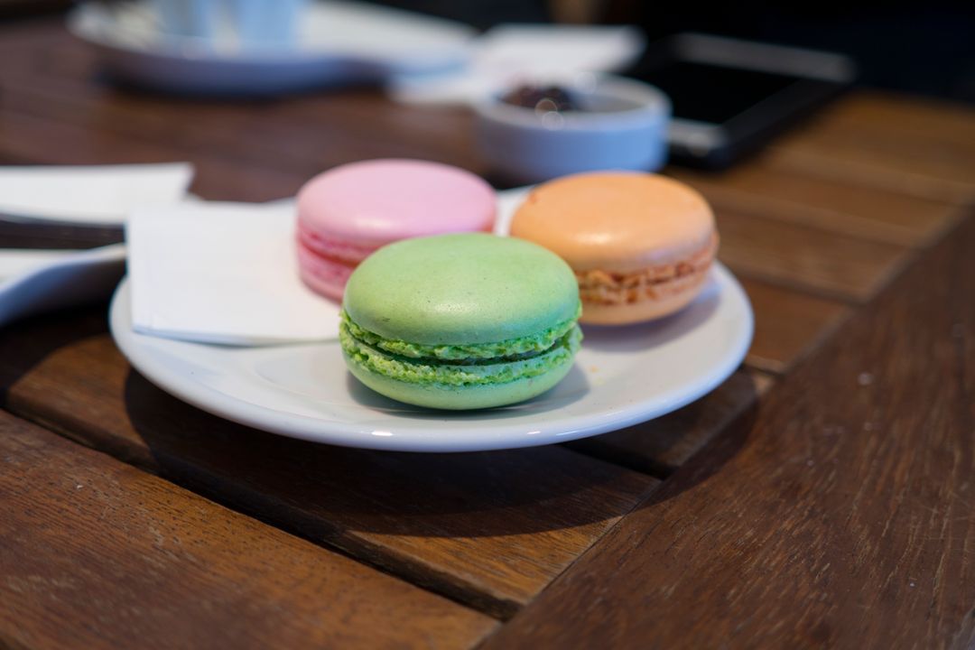 Colorful Macarons on a Wooden Table in a Cafe Setting