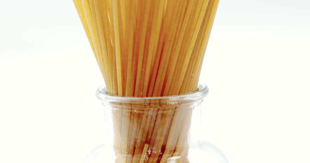 Uncooked Spaghetti Pasta in Glass Jar on White Background - Free Images, Stock Photos and Pictures on Pikwizard.com