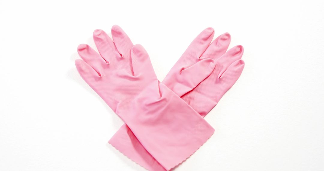 A pair of pink rubber gloves is laid out on a white background, with copy space - Free Images, Stock Photos and Pictures on Pikwizard.com
