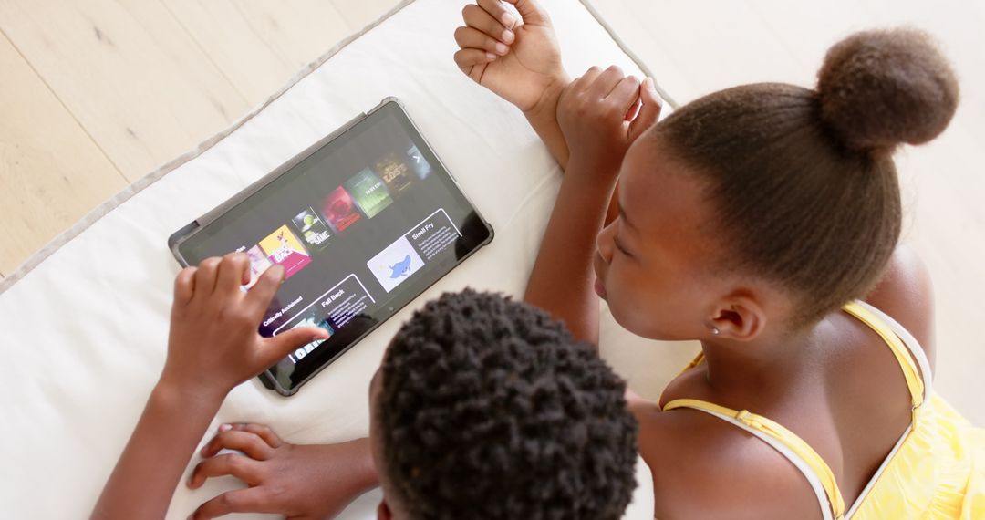 Siblings Browsing Educational Content on Tablet Together