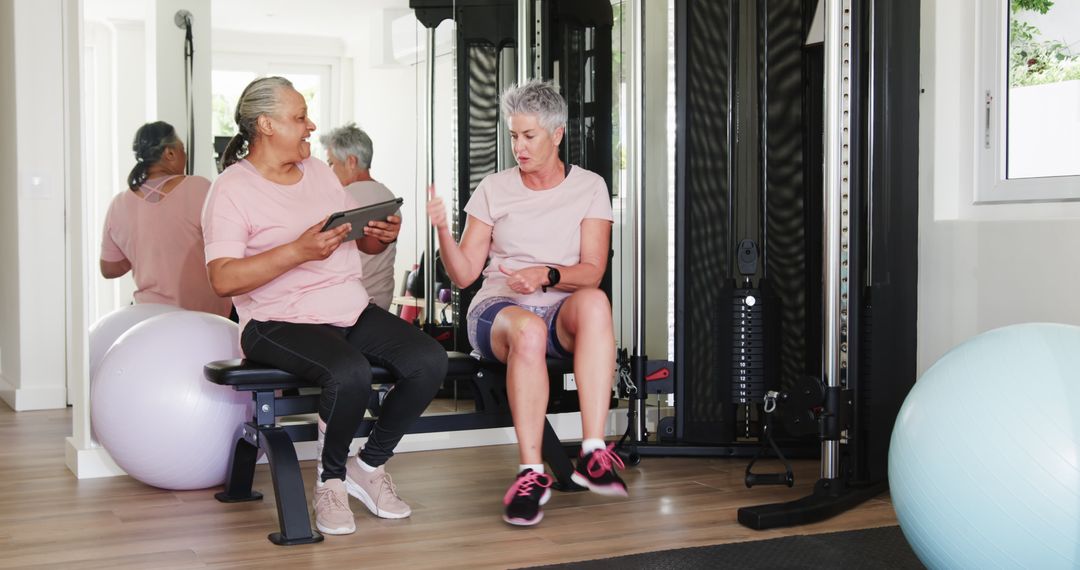 Senior Couples Engaging in Fitness Activity with Tablet
