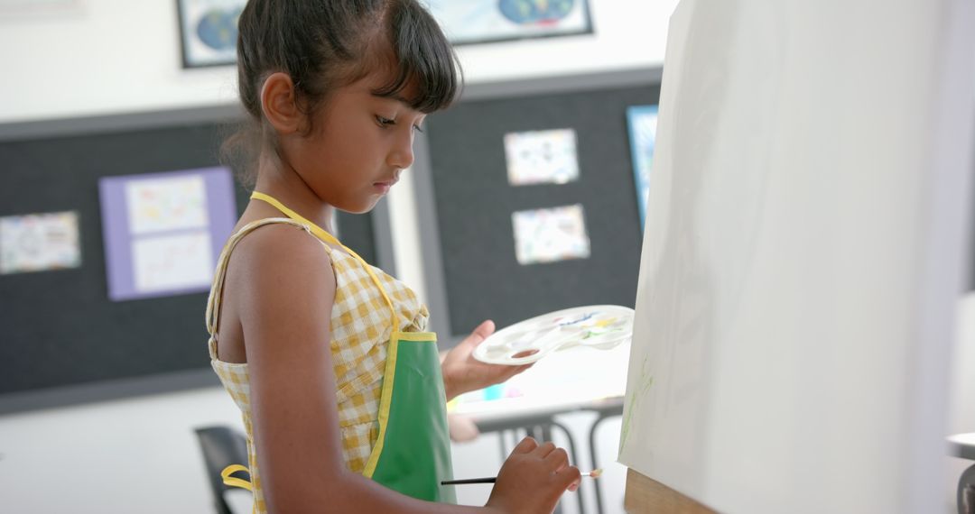 Young Girl Painting on Canvas in Creative Classroom Setting