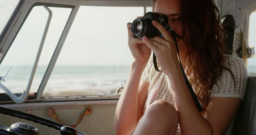 Young Woman Taking Photos from Inside Car by Beach - Free Images, Stock Photos and Pictures on Pikwizard.com