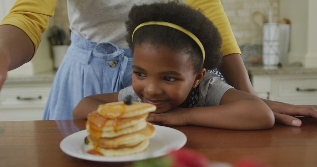 Mother and Daughter Bonding Over Pancake Breakfast at Home