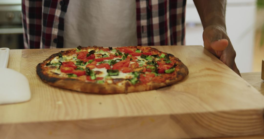 Freshly Baked Vegetable Pizza on Wooden Board in Kitchen - Free Images, Stock Photos and Pictures on Pikwizard.com