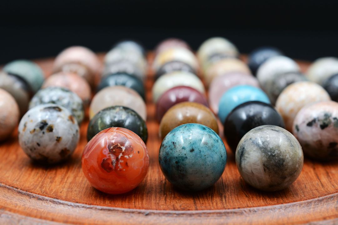 Polished Gemstone Spheres on Wooden Board - Free Images, Stock Photos and Pictures on Pikwizard.com
