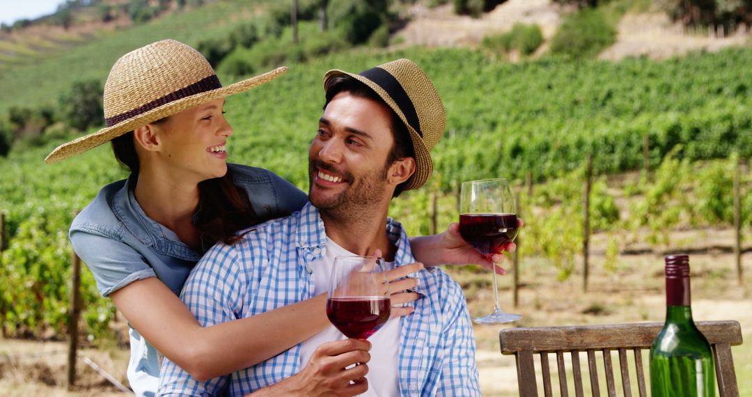 Couple Enjoying Wine in Vineyard on Sunny Day - Free Images, Stock Photos and Pictures on Pikwizard.com