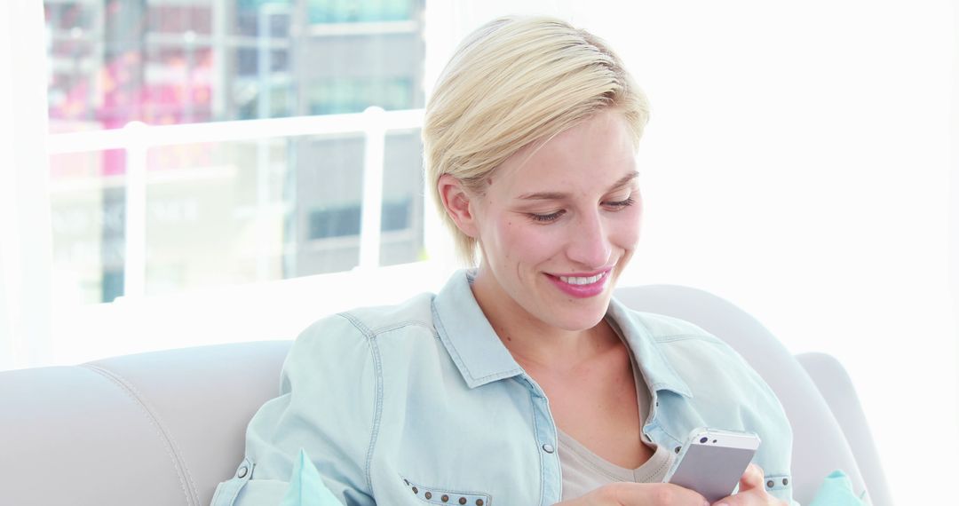 Woman Relaxing on Couch Using Smartphone Indoors Bright Light - Free Images, Stock Photos and Pictures on Pikwizard.com