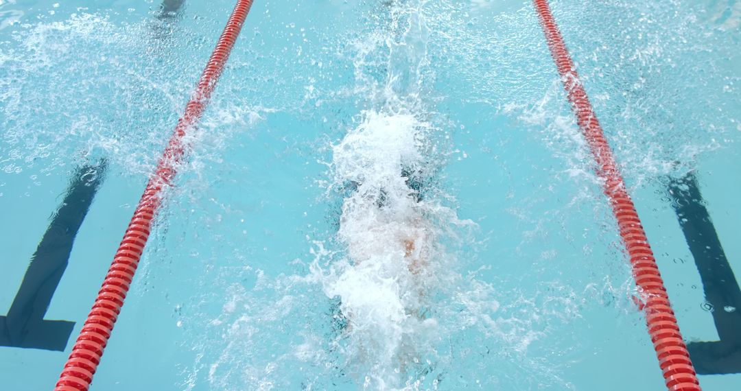 Swimmer Competing in Pool with Energetic Splash