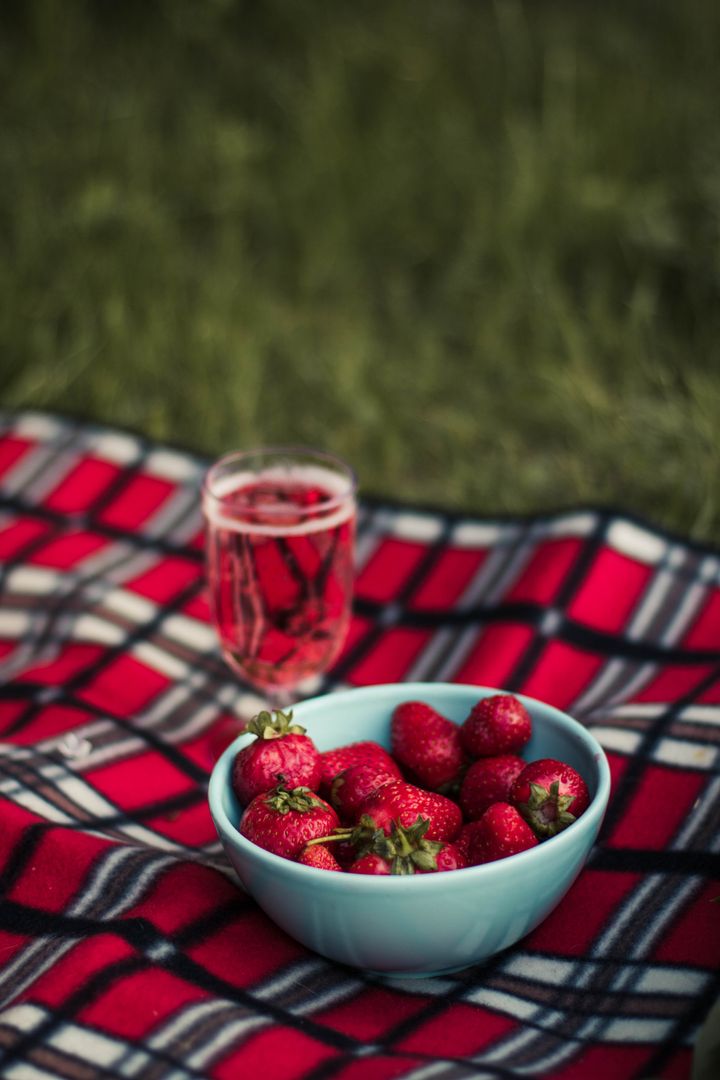 Fresh Strawberries in Bowl on Checkered Picnic Blanket