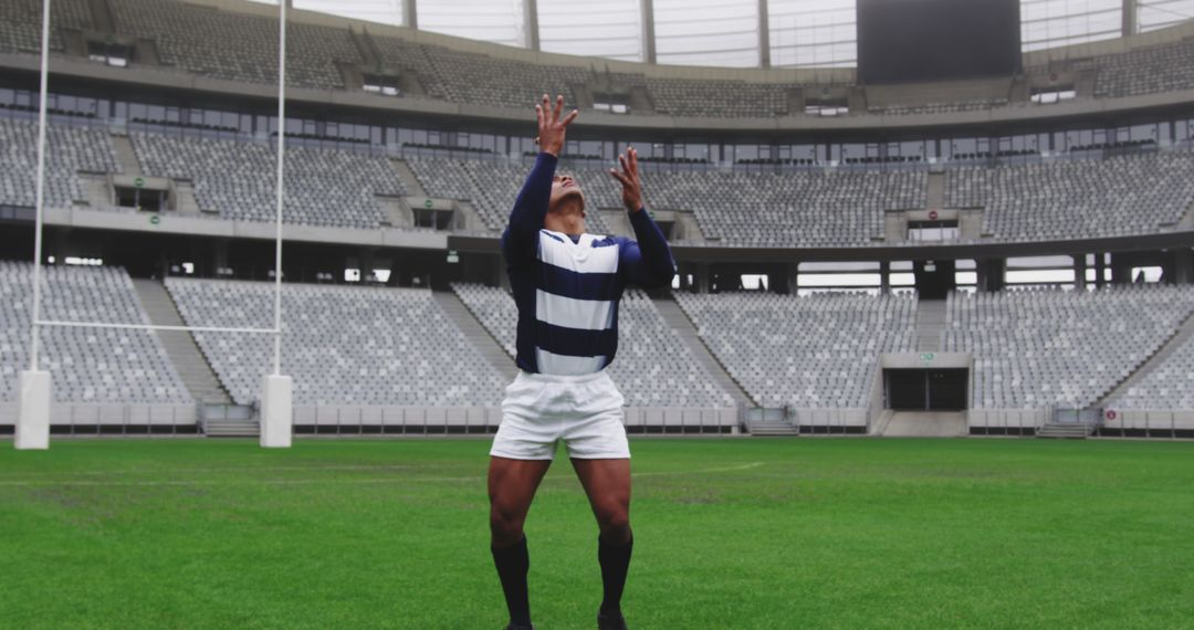 Rugby Player Practicing Catching Drill in Empty Stadium - Free Images, Stock Photos and Pictures on Pikwizard.com