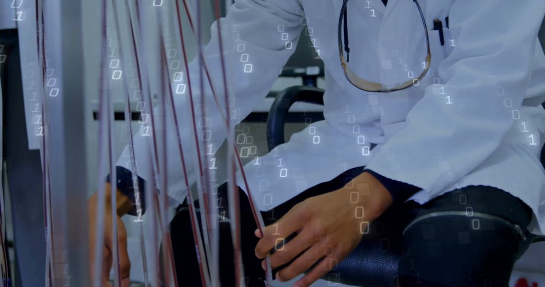 Technician Arranging Cables in a Clinical Laboratory