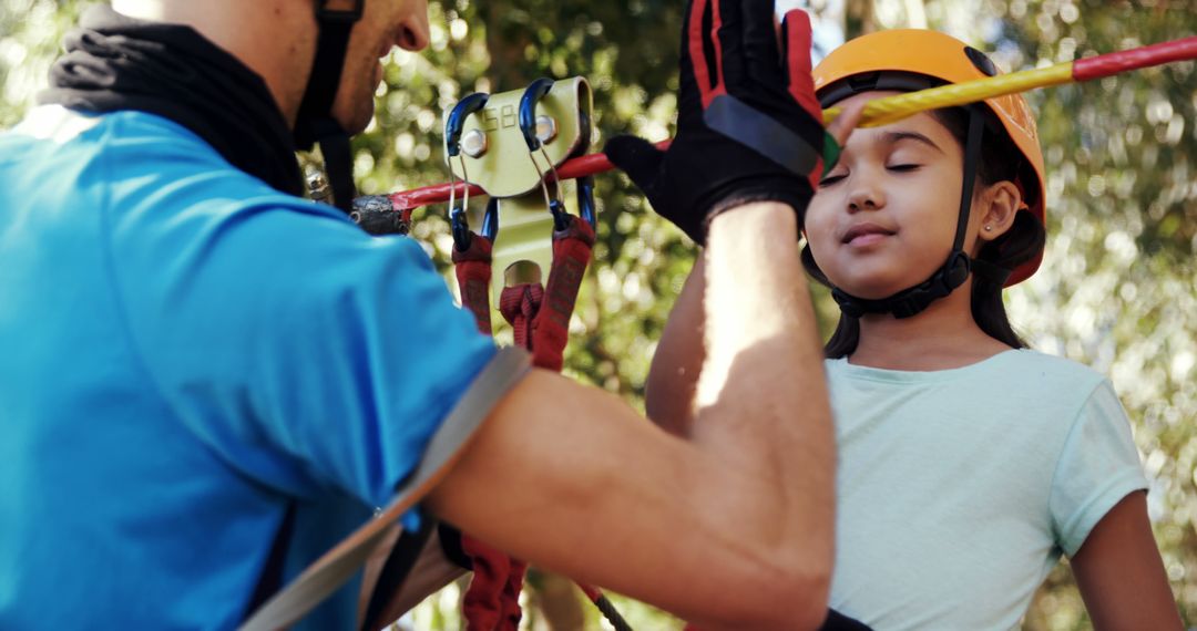 Instructor Helping Child with Outdoor Adventure Gear