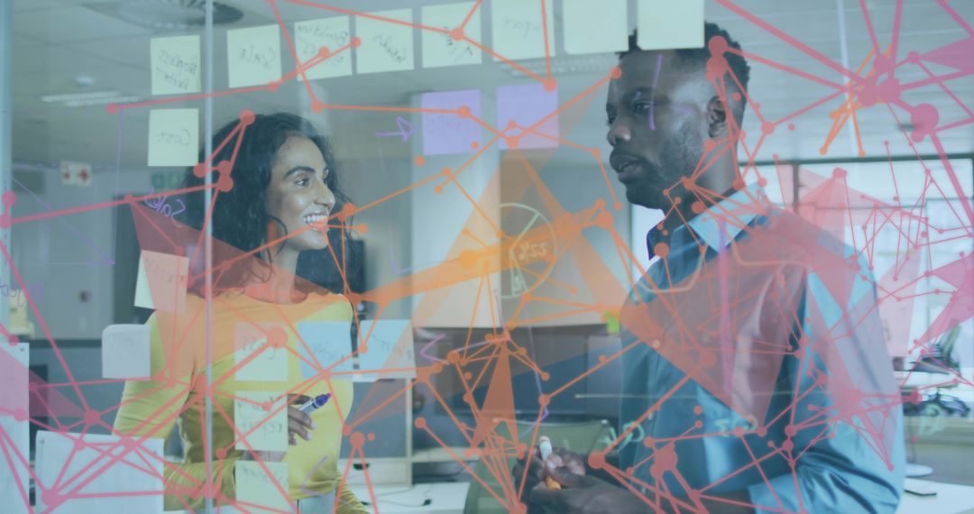 Coworkers Brainstorming Behind Glass in Modern Office with Network Graphic