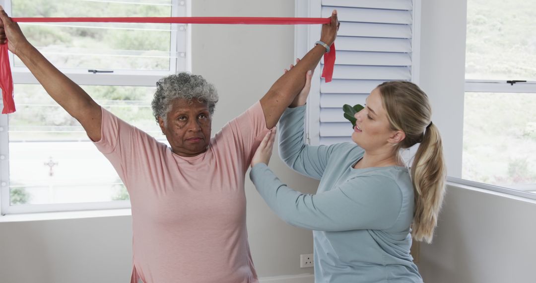 Physical Therapist Assisting Senior Woman During Resistance Band Exercises - Free Images, Stock Photos and Pictures on Pikwizard.com