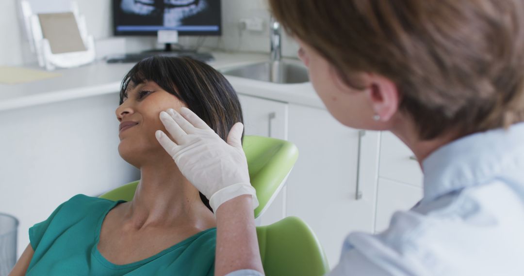 Female Dentist Examining Young Woman's Jaw in Dental Office - Free Images, Stock Photos and Pictures on Pikwizard.com