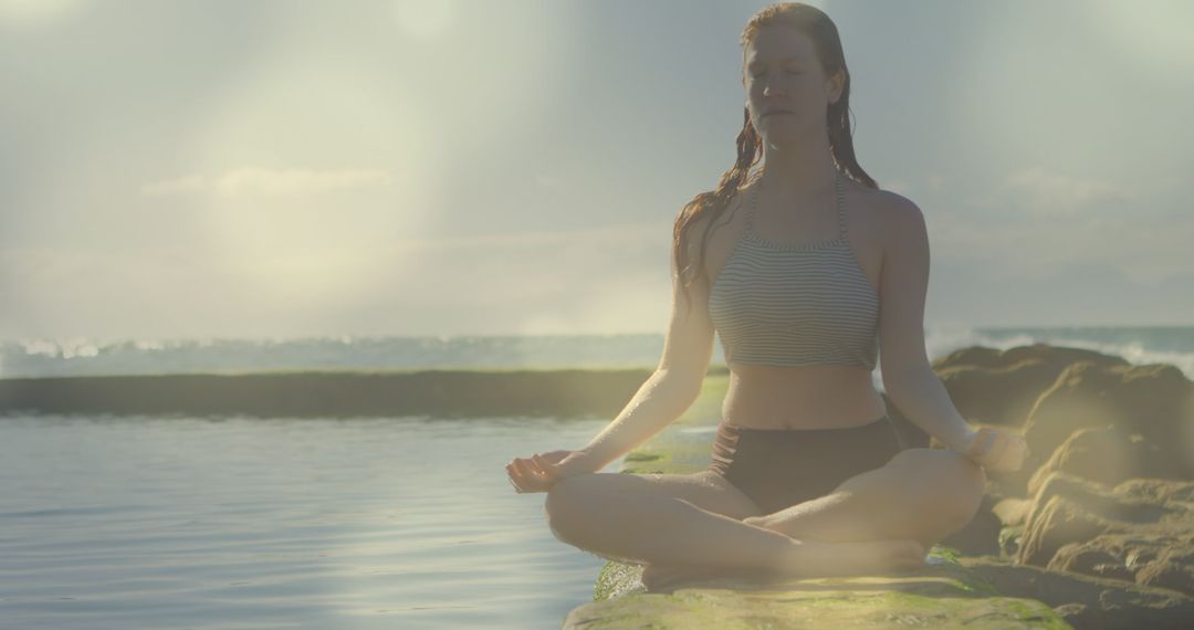 Woman Meditating in Lotus Position by Ocean at Sunrise - Free Images, Stock Photos and Pictures on Pikwizard.com