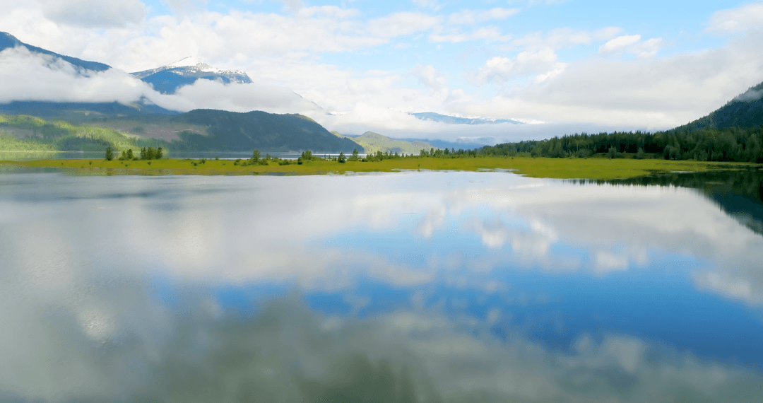 Serene Lake Under Transparent Clouds with Mountain Views
