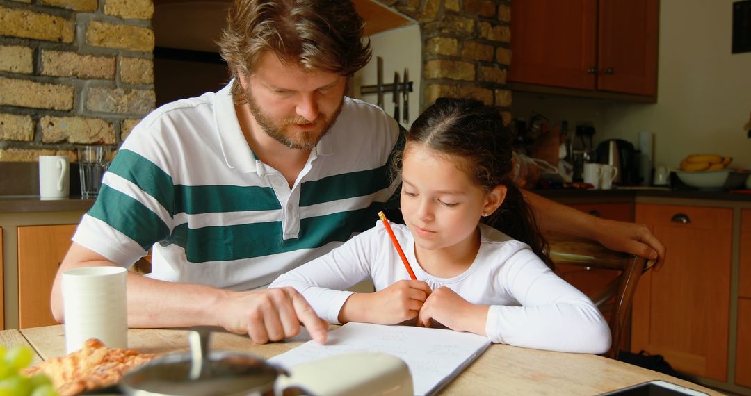 Caucasian Father Helping Daughter with Homework at Kitchen Table - Free Images, Stock Photos and Pictures on Pikwizard.com