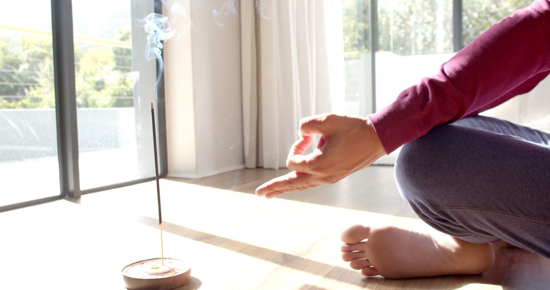 Man Meditating at Home with Incense for Mindfulness and Relaxation