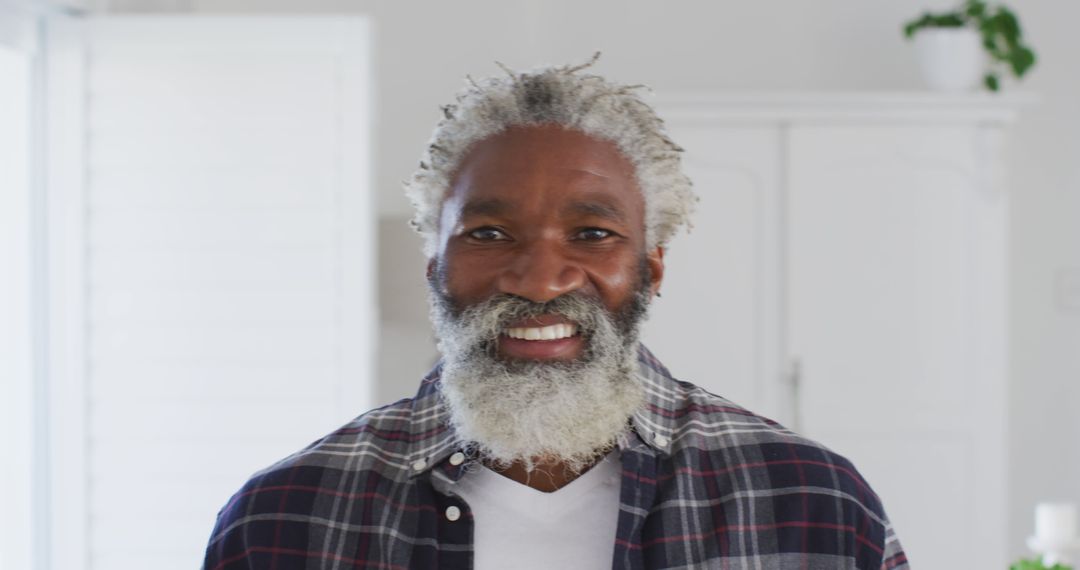 Portrait of happy African American senior man with white hair and beard at home, smiling to camera - Free Images, Stock Photos and Pictures on Pikwizard.com