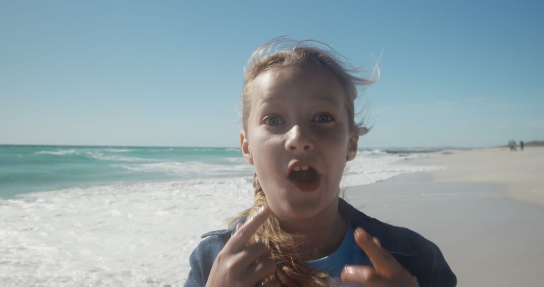 Excited Young Girl Speaking at Seaside Beachfront - Free Images, Stock Photos and Pictures on Pikwizard.com