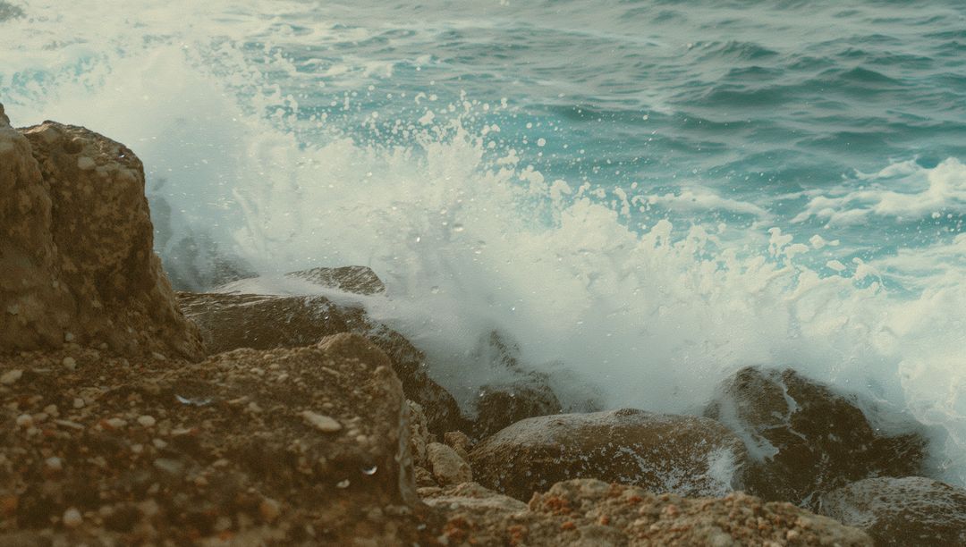 Crashing Waves on Rocky Shoreline with Frothy Spray