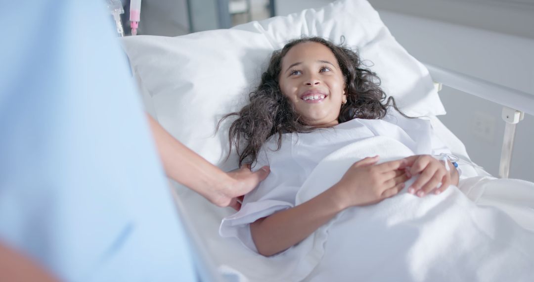 Smiling Young Girl Being Comforted in Hospital Bed by Nurse - Free Images, Stock Photos and Pictures on Pikwizard.com