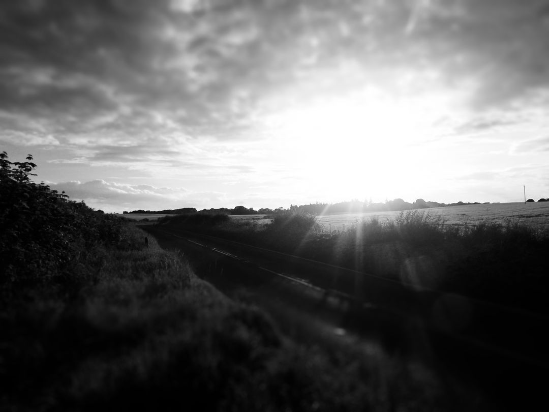 Black and White Rural Sunset Scene with Road and Fields - Free Images, Stock Photos and Pictures on Pikwizard.com