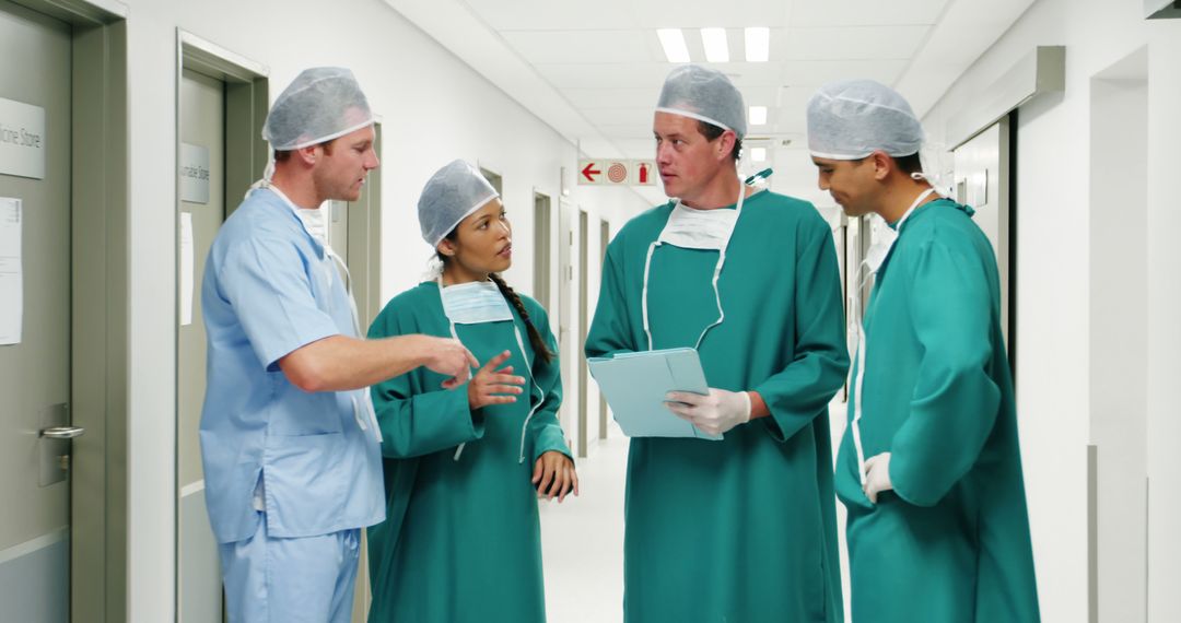 Doctors Discussing Medical Case in Hospital Corridor - Free Images, Stock Photos and Pictures on Pikwizard.com