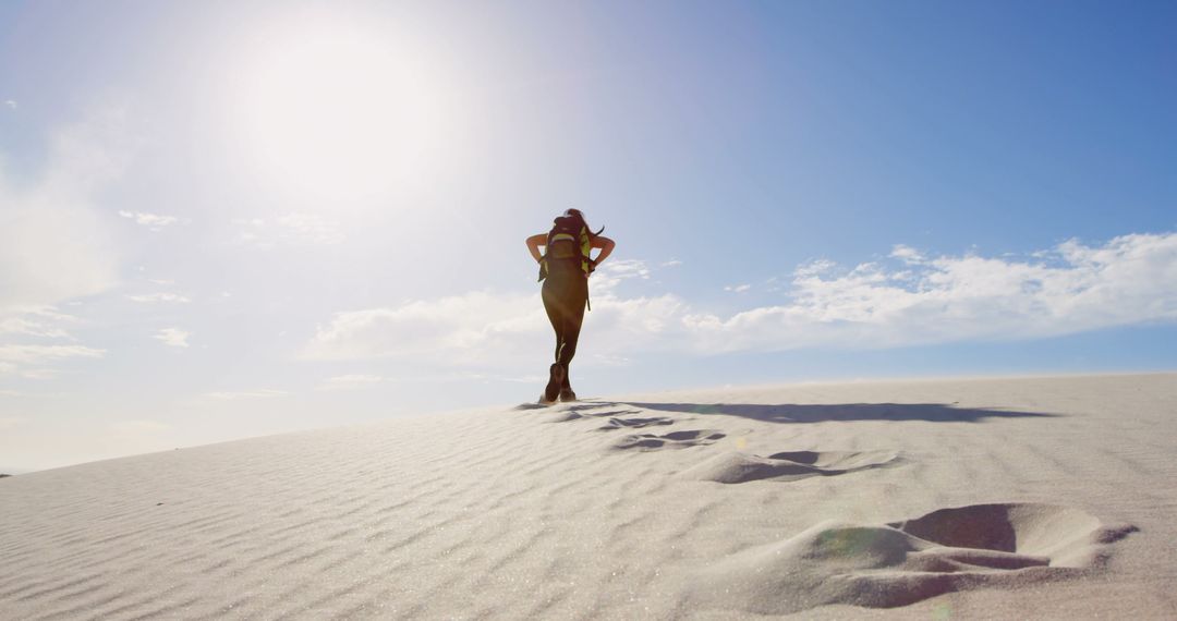 Woman Trekking Desert Sand Dunes on Sunny Day - Free Images, Stock Photos and Pictures on Pikwizard.com