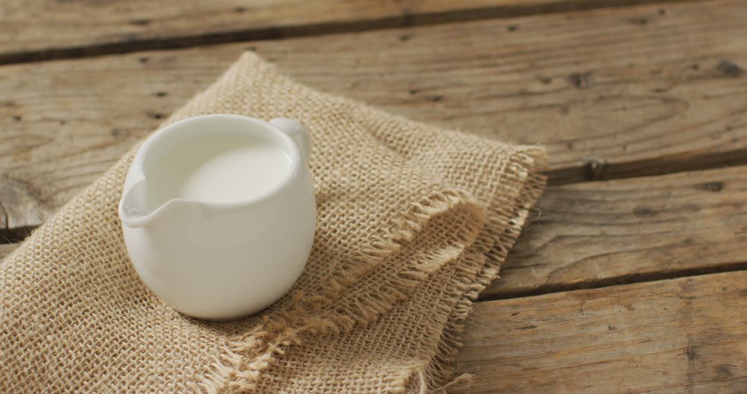 Image of glass jug of milk on wooden background - Free Images, Stock Photos and Pictures on Pikwizard.com