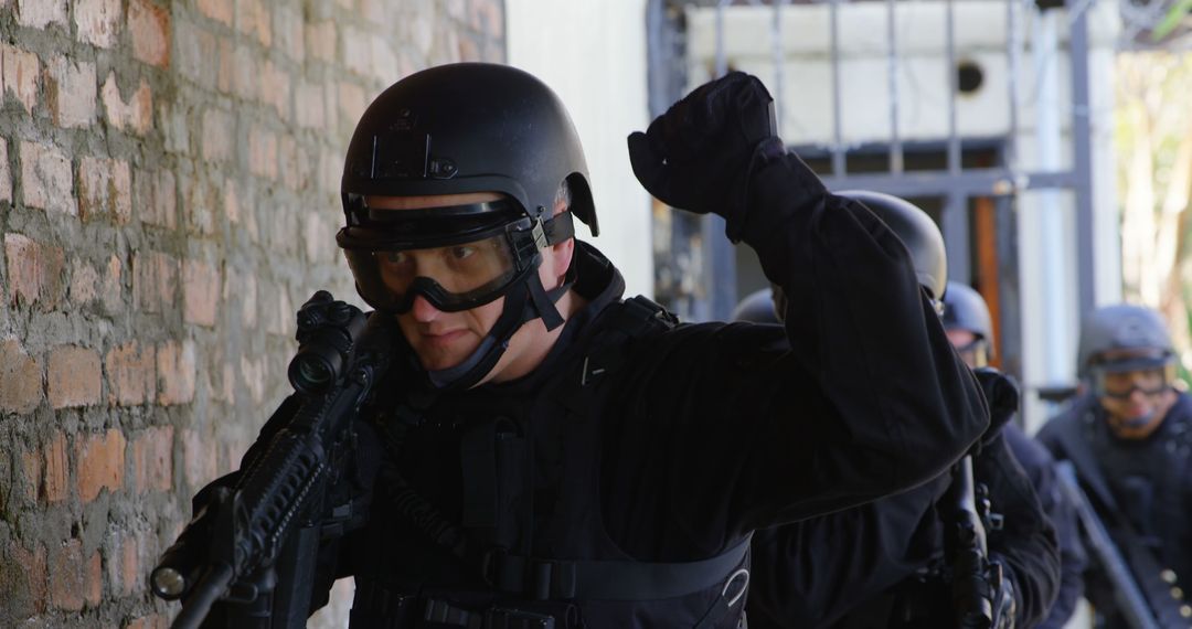 Tactical Police Team Conducting Operation Near Brick Wall - Free Images, Stock Photos and Pictures on Pikwizard.com