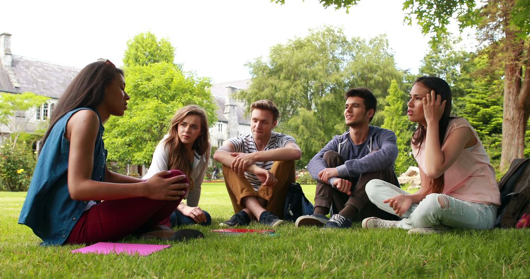 Group of Young Students Relaxing and Chatting Outdoors on Campus - Free Images, Stock Photos and Pictures on Pikwizard.com