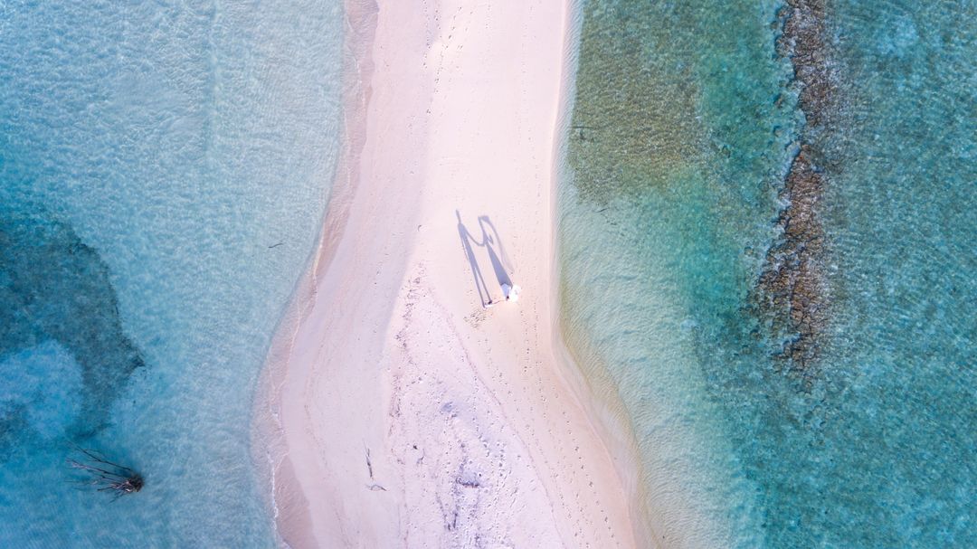 Aerial View of Serene Beach with Calm Azure Waters
