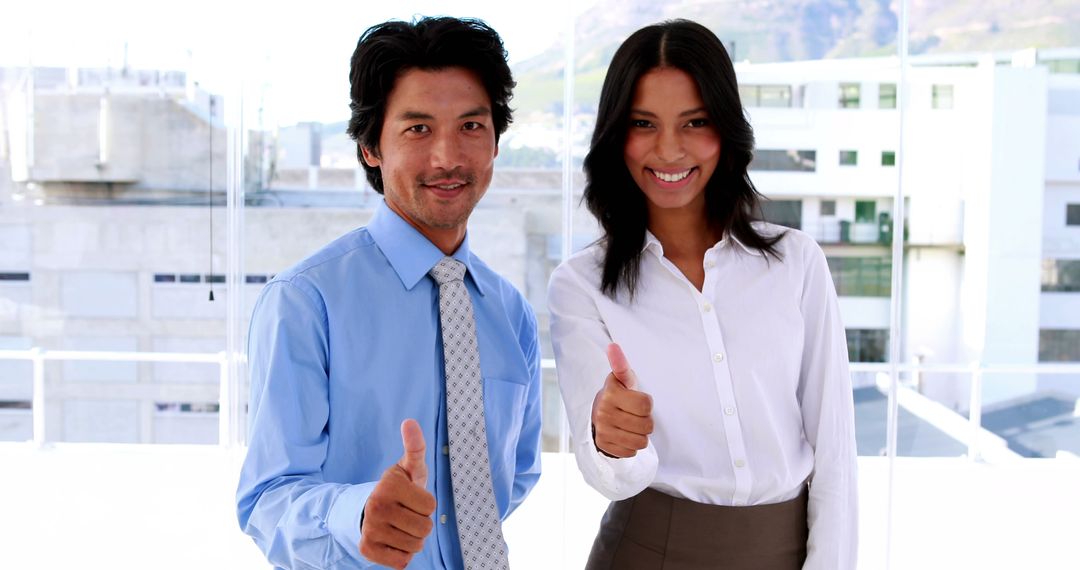 Diverse Professionals Smiling and Giving Thumbs Up in Modern Office - Free Images, Stock Photos and Pictures on Pikwizard.com