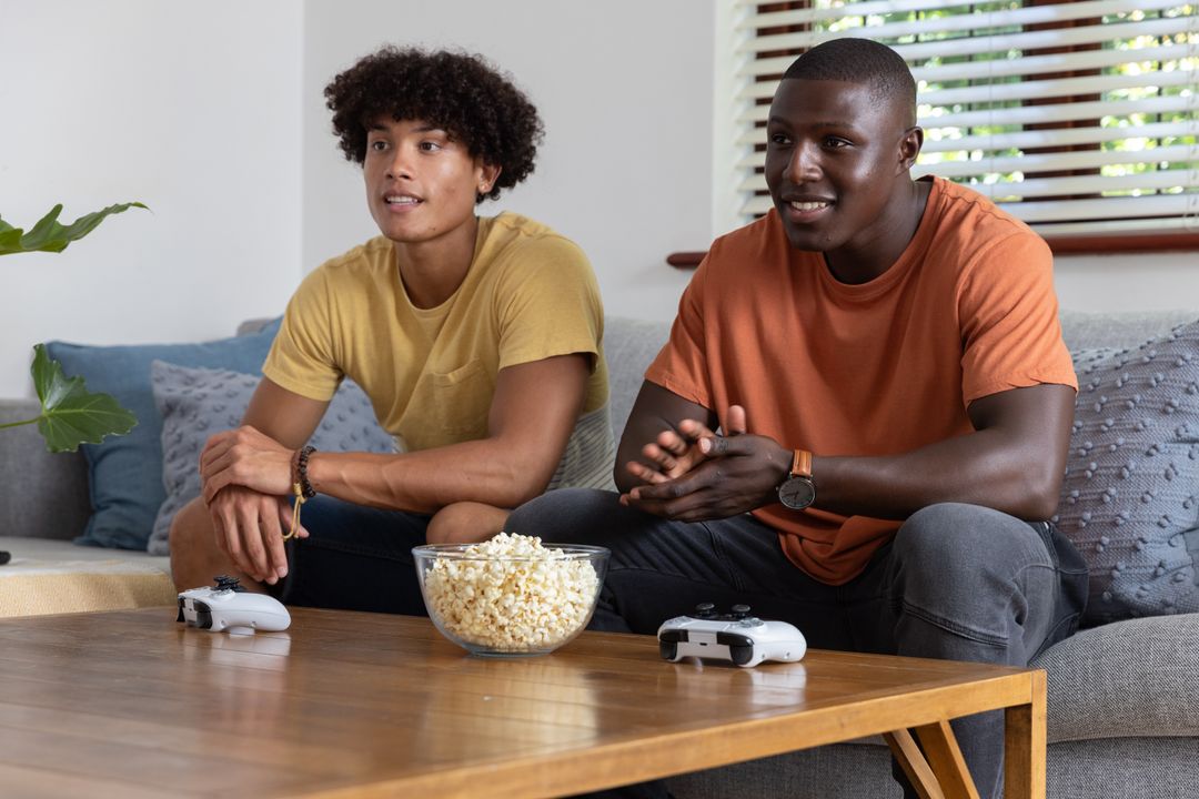 Diverse Friends Enthusiastically Gaming and Bonding at Home