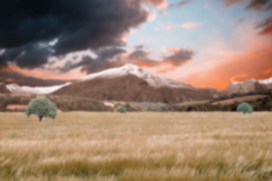 Transparent Scenic Field by Mountain During Clouded Sunset