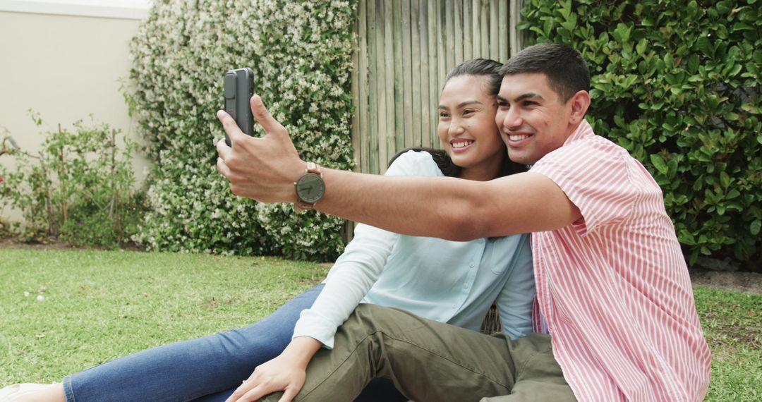 Young Couple Taking Selfie While Relaxing in Garden