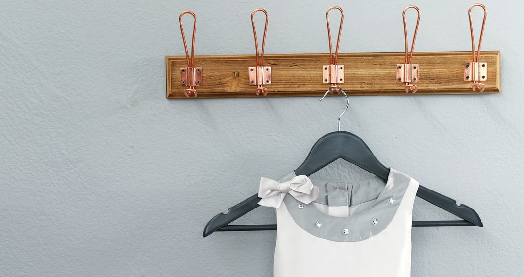 Elegant White Dress Hanging on Hook Rack against Gray Wall - Free Images, Stock Photos and Pictures on Pikwizard.com