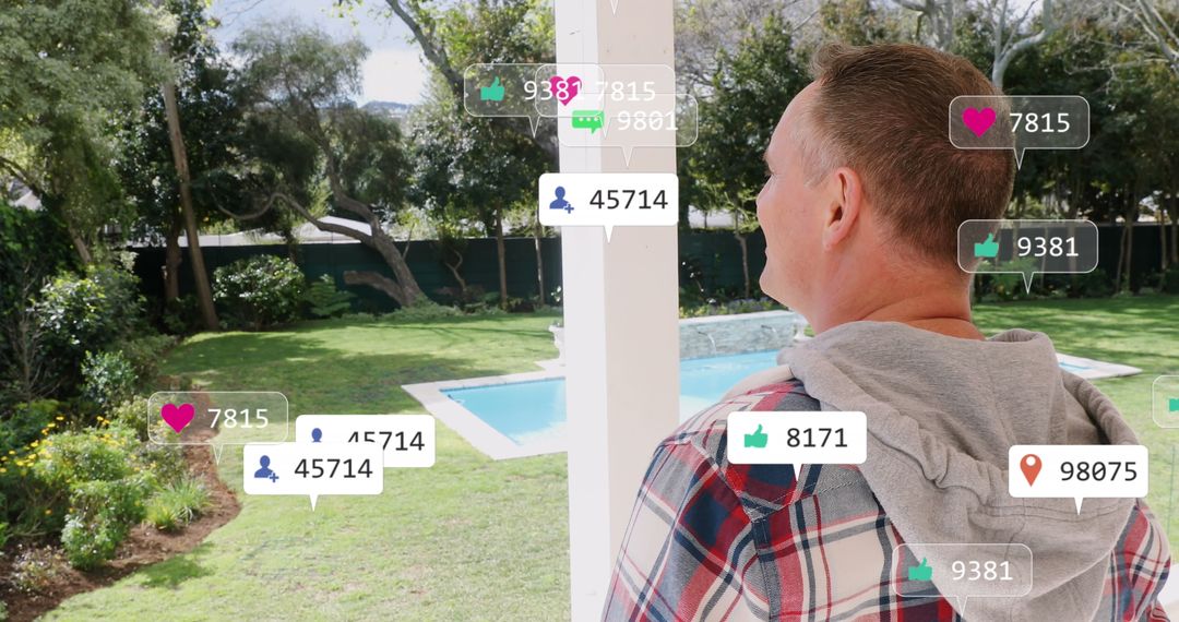 Caucasian Man Observing Social Media Icons in Lush Garden