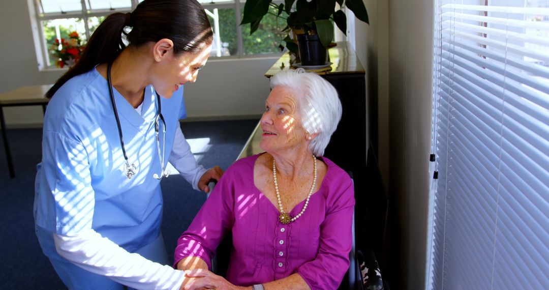 Nurse Comforting Elderly Woman in Nursing Home Care