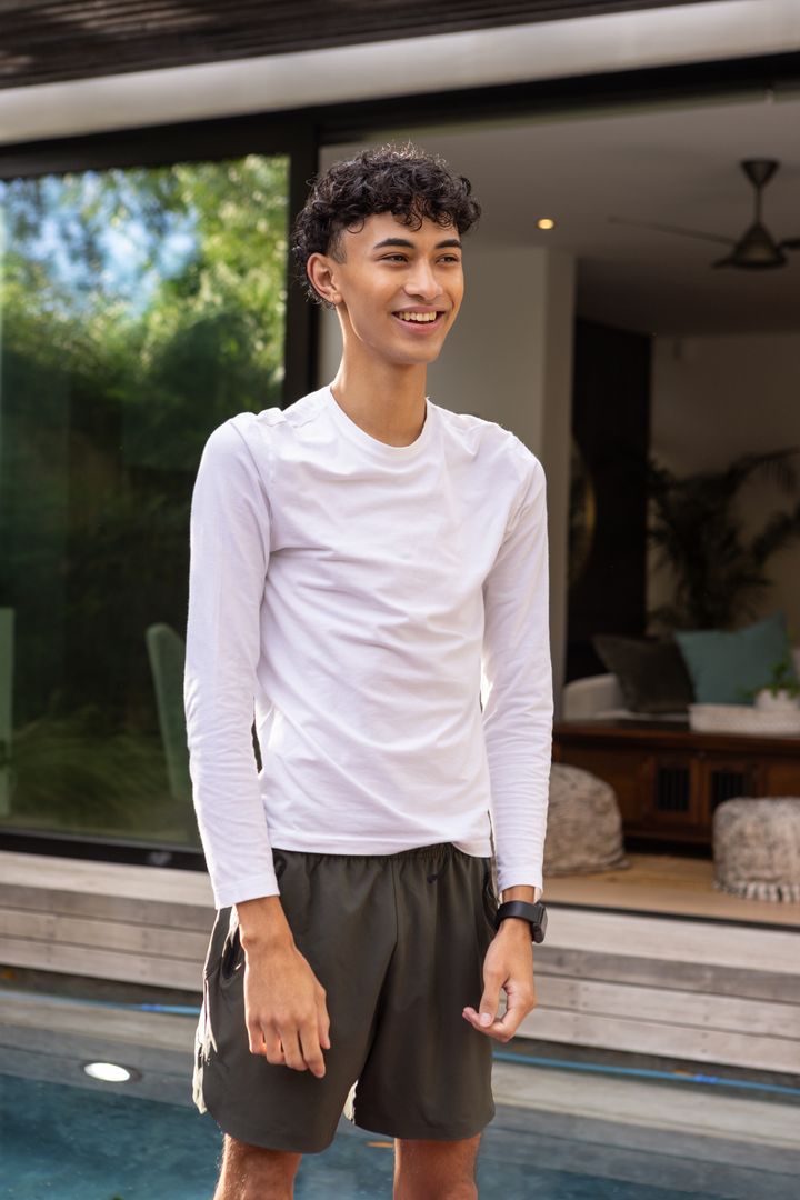 Young Man Enjoying Outdoor Relaxation by Modern Poolside
