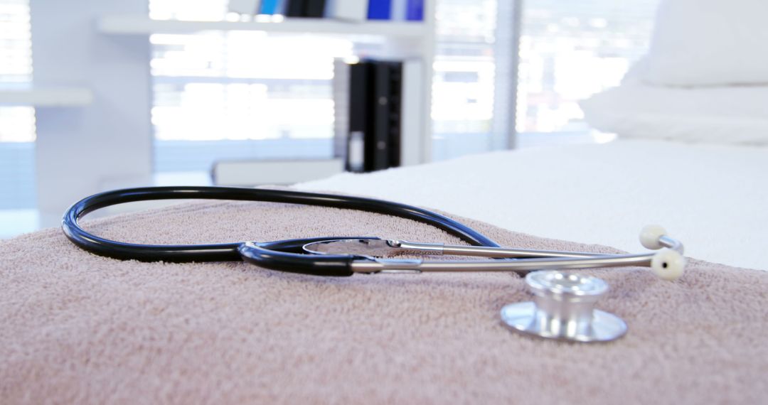 A stethoscope rests on a towel in a medical setting, with copy space - Free Images, Stock Photos and Pictures on Pikwizard.com