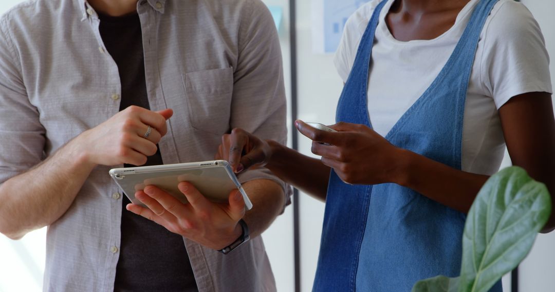 Colleagues Collaborating with Tablet and Smartphones in Office