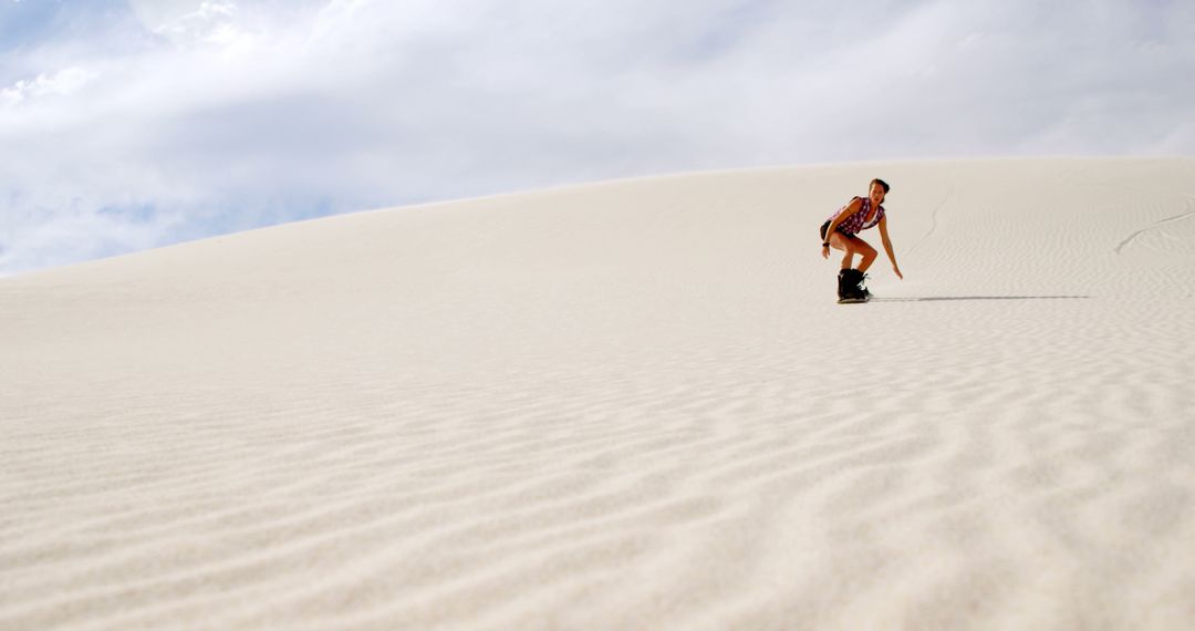 Adventurous Woman Sandboarding on Expansive Desert Dunes